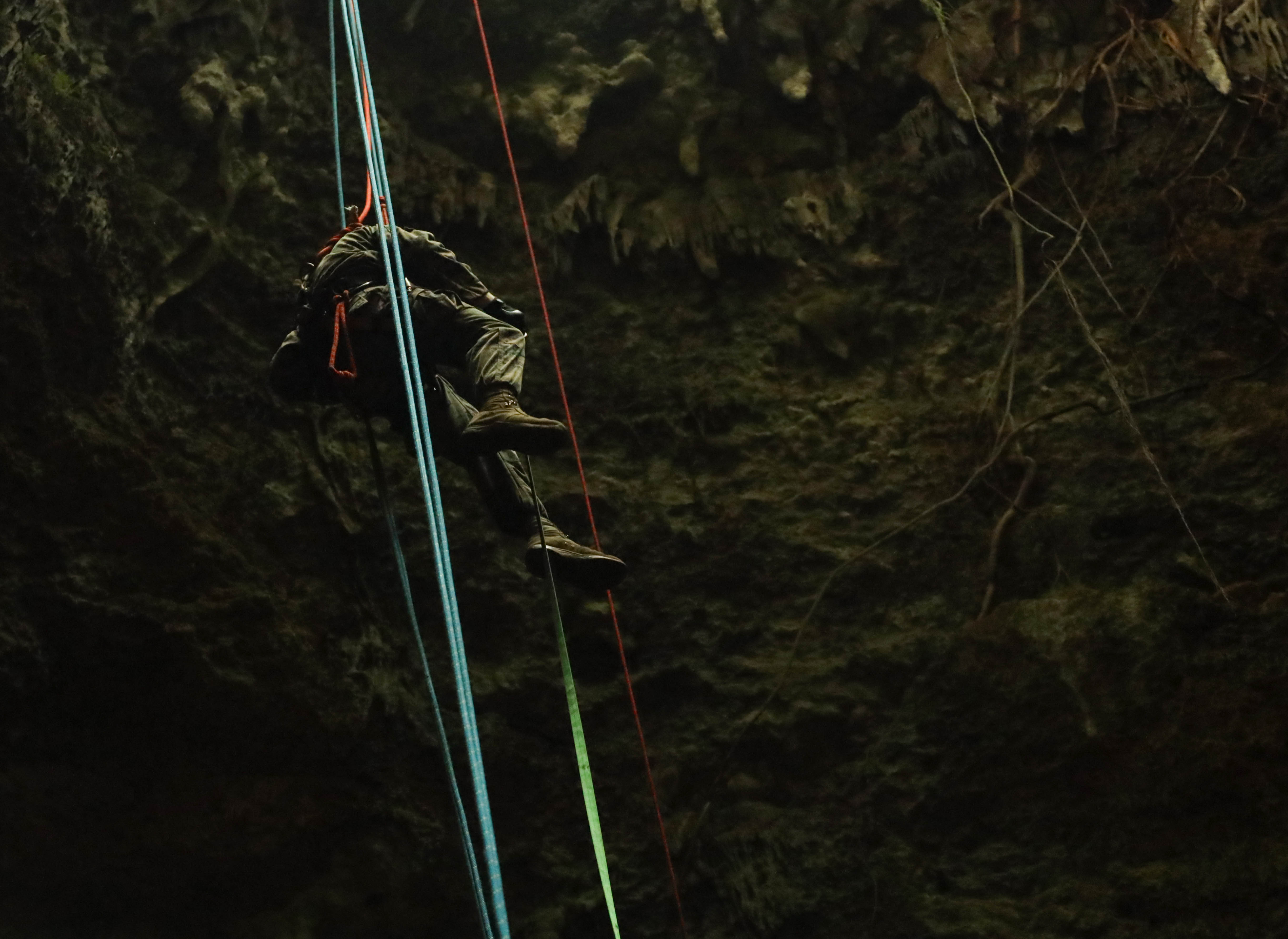 A U.S. Marine with Chemical, Biological, Radiological, and Nuclear Defense Platoon, Headquarters Battalion, 3d Marine Division, rappels into a cave during the culminating event of a rope rescue technician certification course at Marine Corps Air Station Futenma, Okinawa, Japan, March 23, 2023. The course, taught by U.S. Air Force firefighters, prepares Marines to respond to disaster situations and builds interoperability between joint forces for crisis response operations. (U.S. Marine Corps photo by Lance Cpl. Evelyn Doherty)